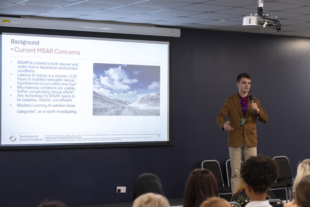 A student presents his research on using artificial intelligence in mountain rescue