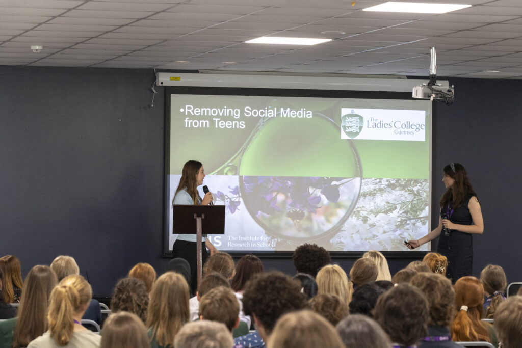 Two female students present the project on social media usage at Exeter