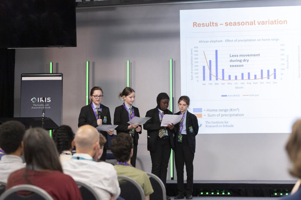Four female students present their research on stage in Manchester