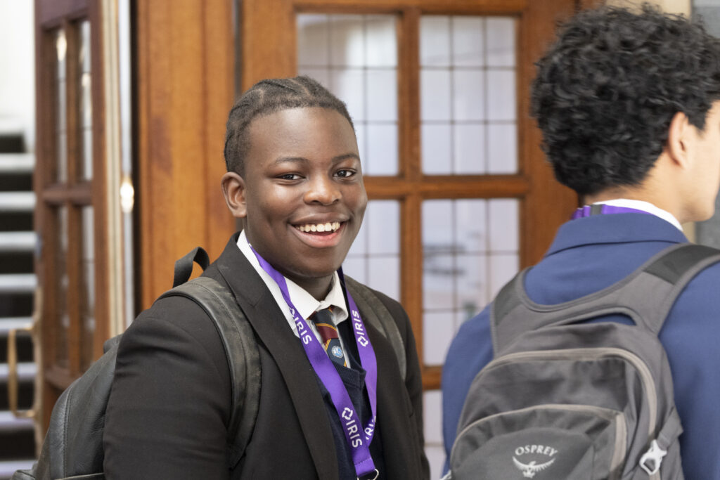 A boy smiles at the camera
