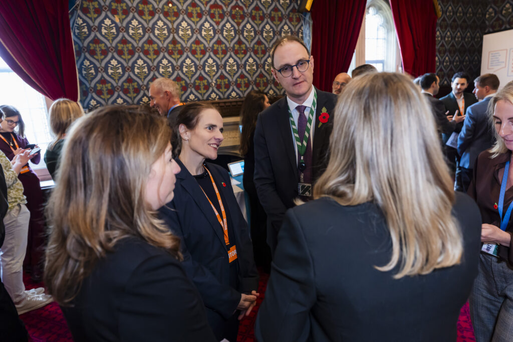 Members of IRIS and Ian Sollom MP, speaking in parliament