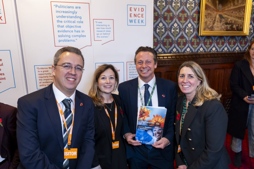 Members of IRIS posing for a photo with Nigel Huddleston MP at Parliament