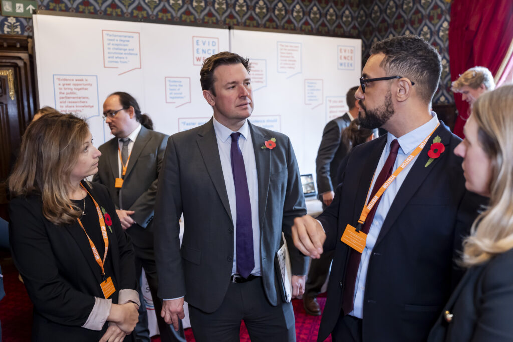 Members of IRIS speaking with Steve Race in Parliament